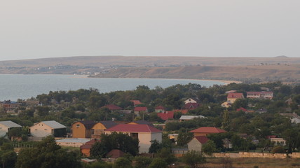 roofs of a small resort town on the coast of the sea in the sunset sun