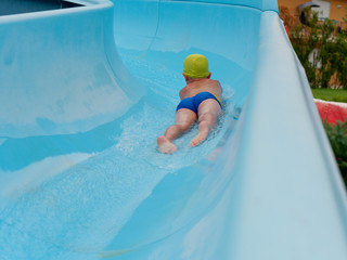 boy rides water slide rides at the water park