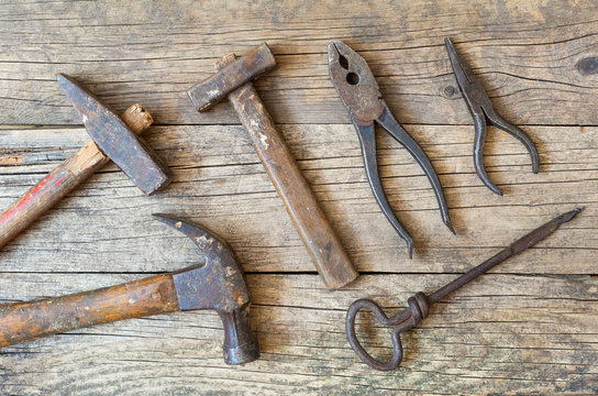 Old vintage tools on wooden background, flat lay, top view