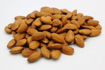pile of almonds isolated on white background