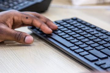 African man hands typing on keyboard