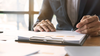 Business man working a project of financial plan for marketing.