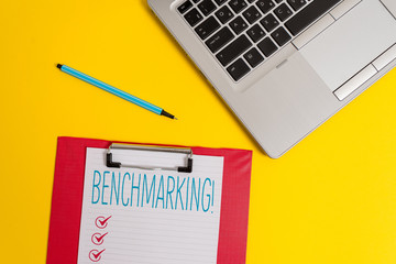 Writing note showing Benchmarking. Business concept for evaluate something by comparison with standard or scores Trendy metallic laptop clipboard paper sheet marker colored background