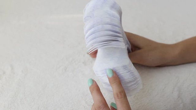 Girl fingering daily sanitary pads concept of cleanliness and hygiene, close-up, menstruation