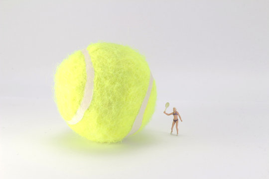 Tiny toys play tennis on the big tennis
