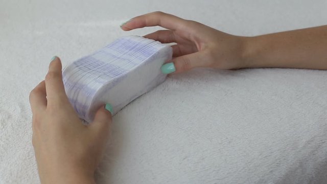 Girl fingering daily sanitary pads concept of cleanliness and hygiene, close-up, menstruation