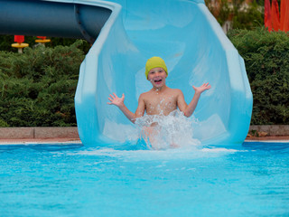 boy rides water slide rides at the water park