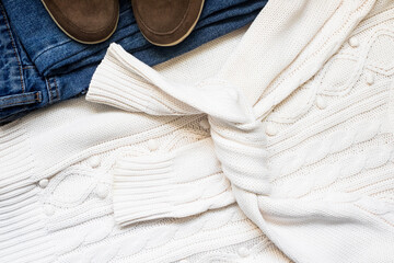 Set of women's autumn, winter clothes - jeans, white pullover oversize, suede brown boots. Fashionable clothes for walks, flat lay