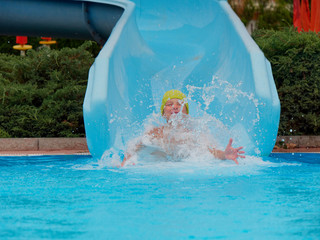 boy rides water slide rides at the water park