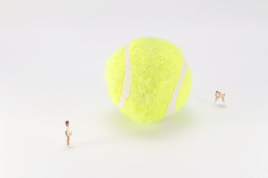 Tiny toys play tennis on the big tennis