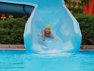 boy rides water slide rides at the water park
