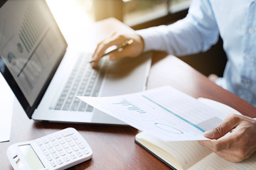 Obraz premium Financial analyst calculating with number documents, Investment concept.