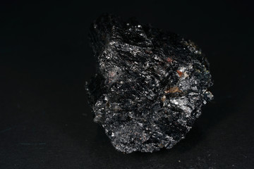 A black rock also called healing stone shungite, which consists mainly of carbon was photographed...