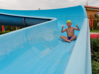 boy rides water slide rides at the water park
