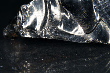 A black rock also called healing stone shungite, which consists mainly of carbon was photographed...
