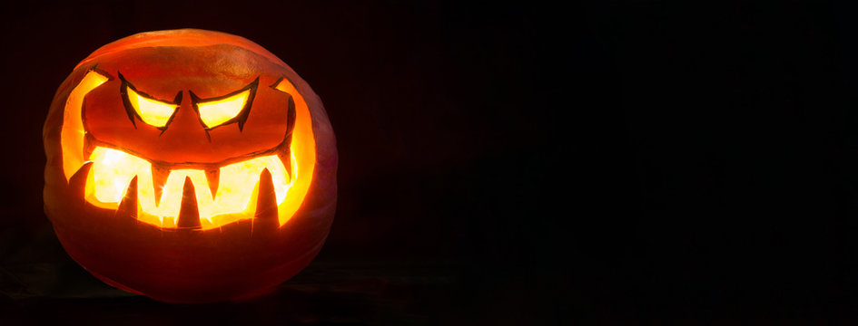Halloween pumpkin smile and scrary eyes for party night. Black background wide mockup