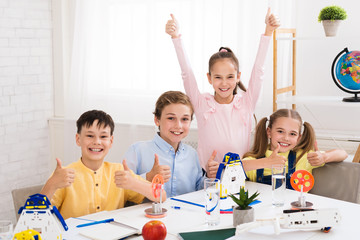 Stem education. Happy children showing thumbs up © Prostock-studio
