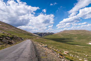 Fototapeta na wymiar Alpine landscape of road and green mountain tops leading to Mount Evans in Colorado