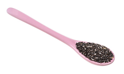 Chia seeds in ceramic spoon cutout on white