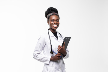 Portrait of happy african medical intern doctor writing on clipboard isolated on white background