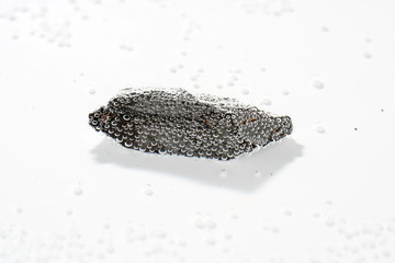 A black rock also called healing stone shungite, which consists mainly of carbon was photographed...