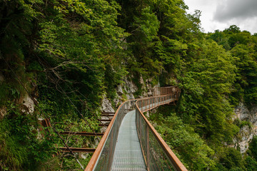 Okatse Canyon in Georgia. Waterfall on the cliffs of the reserve. Beautiful natural canyon, hiking trail over the canyon, overlooking the mountain river, near Kutaisi.