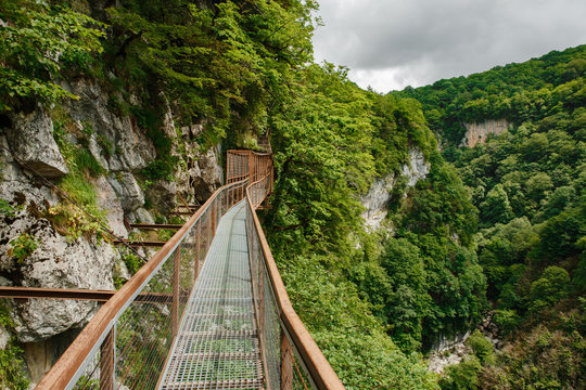 Okatse Canyon in Georgia. Waterfall on the cliffs of the reserve. Beautiful natural canyon, hiking trail over the canyon, overlooking the mountain river, near Kutaisi.