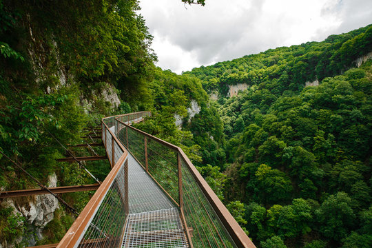Aerial road in Okace (Okatse) canyon - Georgia. All rocks are covered with bright green foliage. Modern tourist landmark and attraction in Georgia mountains.