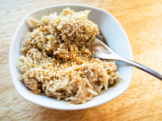 fork in grated kohlrabi salad with sesame close-up