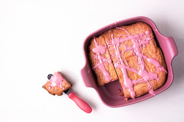 Ruby chocolate cake in a pink tray and a slice separated