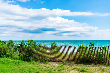 Fototapeta na wymiar Lake Michigan Shoreline with Fence in Evanston Illinois during the Summer