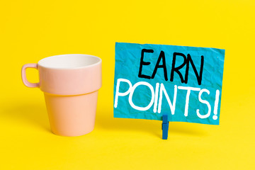 Handwriting text Earn Points. Conceptual photo collecting scores in order qualify to win big prize Cup empty paper blue clothespin rectangle shaped reminder yellow office