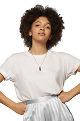 The medium front shot of a young mulatta lady with a steely chainlet with a pendant in the form of screw with a fitted-in brown gemstone similar to a cat's-eye on her neck.  © RedUmbrella&Donkey