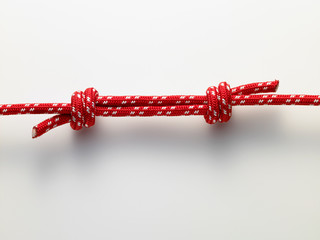 two red rope knot on white background