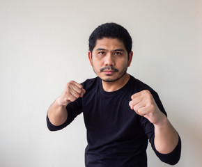 Asian man doing fighting stance. Young man with box stance ready to fight. Aggressive young man...