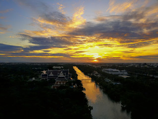 Beautiful sunset sky above the city with sky blue and orange light of the sun through the clouds in the sky, Orange and red dramatic colors, Warm color - Image