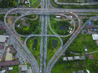 Aerial top view of Toll expressway, Motorway shaped like a triangle or heart, Modern transportation, Multilevel junction highway, Road traffic an important infrastructure in Thailand.