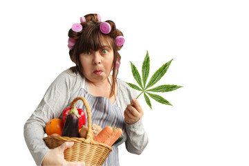 middle-aged woman, a housewife in curlers holds a basket with vegetables in one hand, and hemp leaf in the other