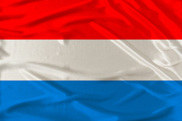 national flag of the Luxembourg on gentle silk with wind folds, travel concept, immigration, politics