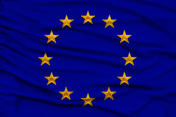 stylized European Union flag, symbol of united Europe on soft silk with soft folds, close-up