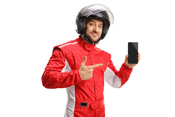 Car racer with a helmet holding a mobile phone and pointing at it