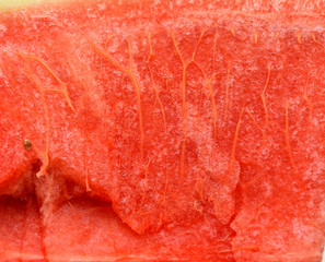 The surface of the pulp of a ripe watermelon with veins. Close-up. Concept - fruit diet. Useful fruits.