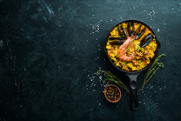 Seafood rice. Paella with mussels and shrimp. Top view. Free space for your text. - obrazy, fototapety, plakaty