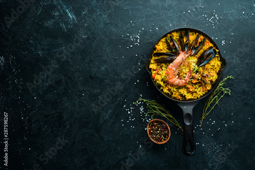 Seafood rice. Paella with mussels and shrimp. Top view. Free space for your text.