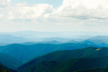 Fototapeta premium Landscape with blue misty silhouettes of mountains.