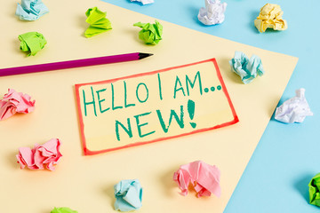 Writing note showing Hello I Am New. Business concept for used as greeting or to begin telephone conversation Colored crumpled papers empty reminder blue yellow clothespin