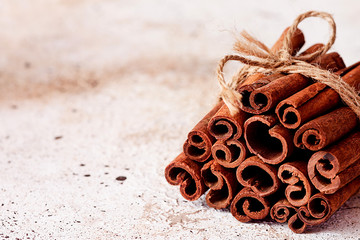 Bunch of cinnamon sticks wrapped with rope on a table