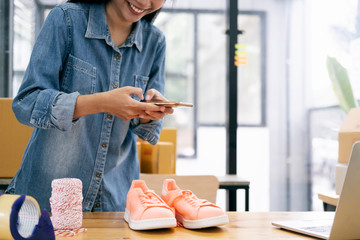 Online seller owner take a photo of product for upload to website online shop.