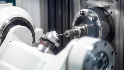 High precision CNC machining center 5 axis working, operator machining automotive sample part...