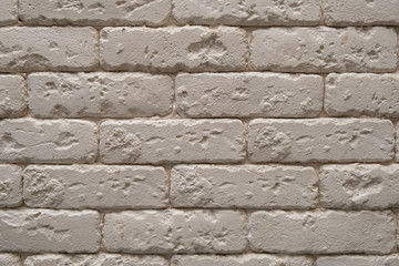 A white or beige brick wall background